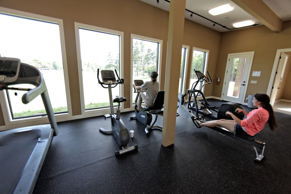 person on rowing machine in indoor gym