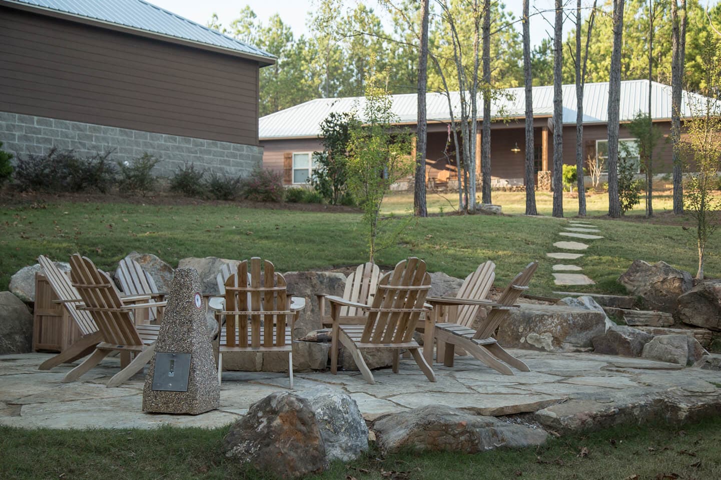 Adirondack chairs surrounding bonfire pit