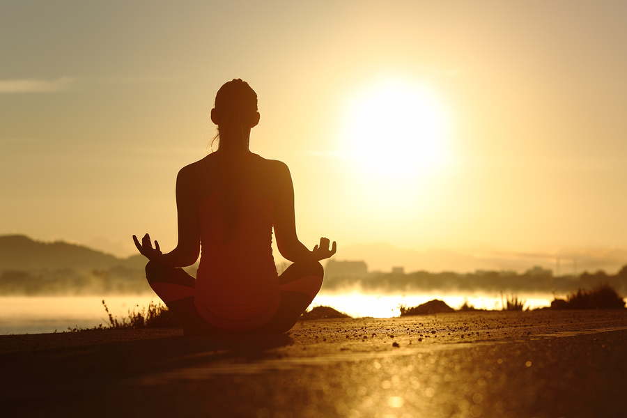 Silhouette Of A Fitness Woman Doing Yoga and Meditation Exercises
