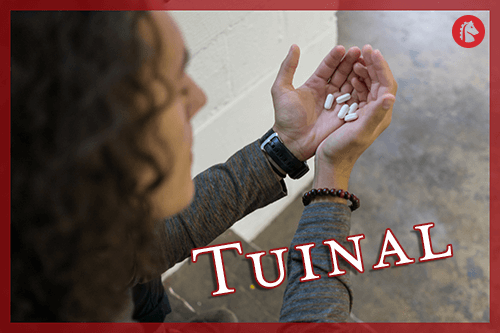 man holding tuinal pills