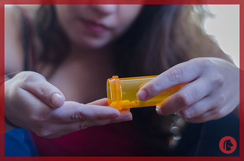 girl pouring prescription pills into her hand