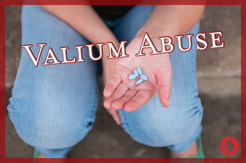 hand holding multiple prescription valium pills