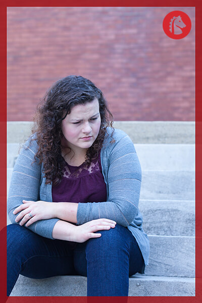girl sitting outside pondering her alcoholism