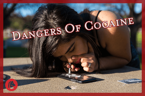 woman snorting cocaine on a table