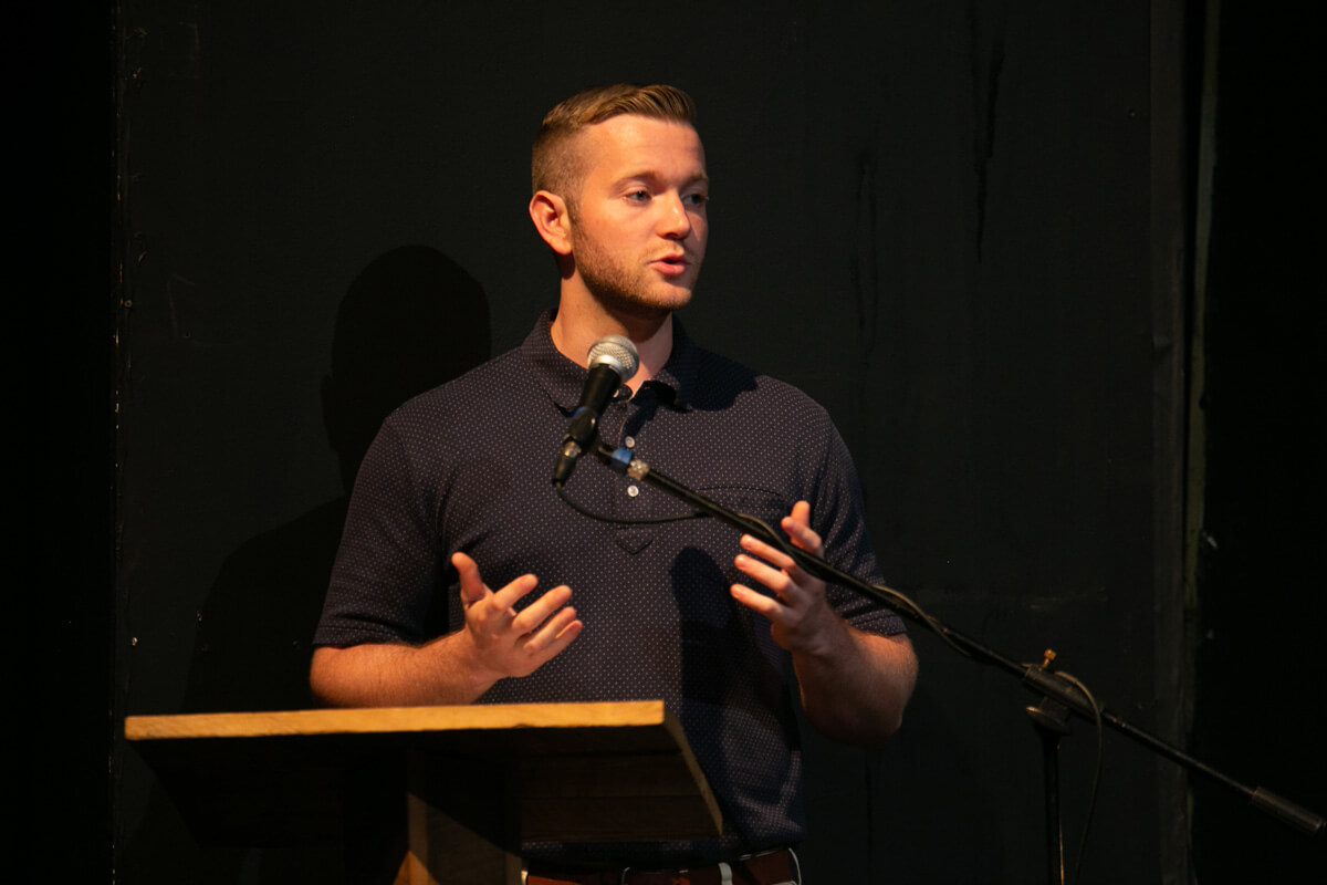 Kyle Donnelly, man at podium gives speech